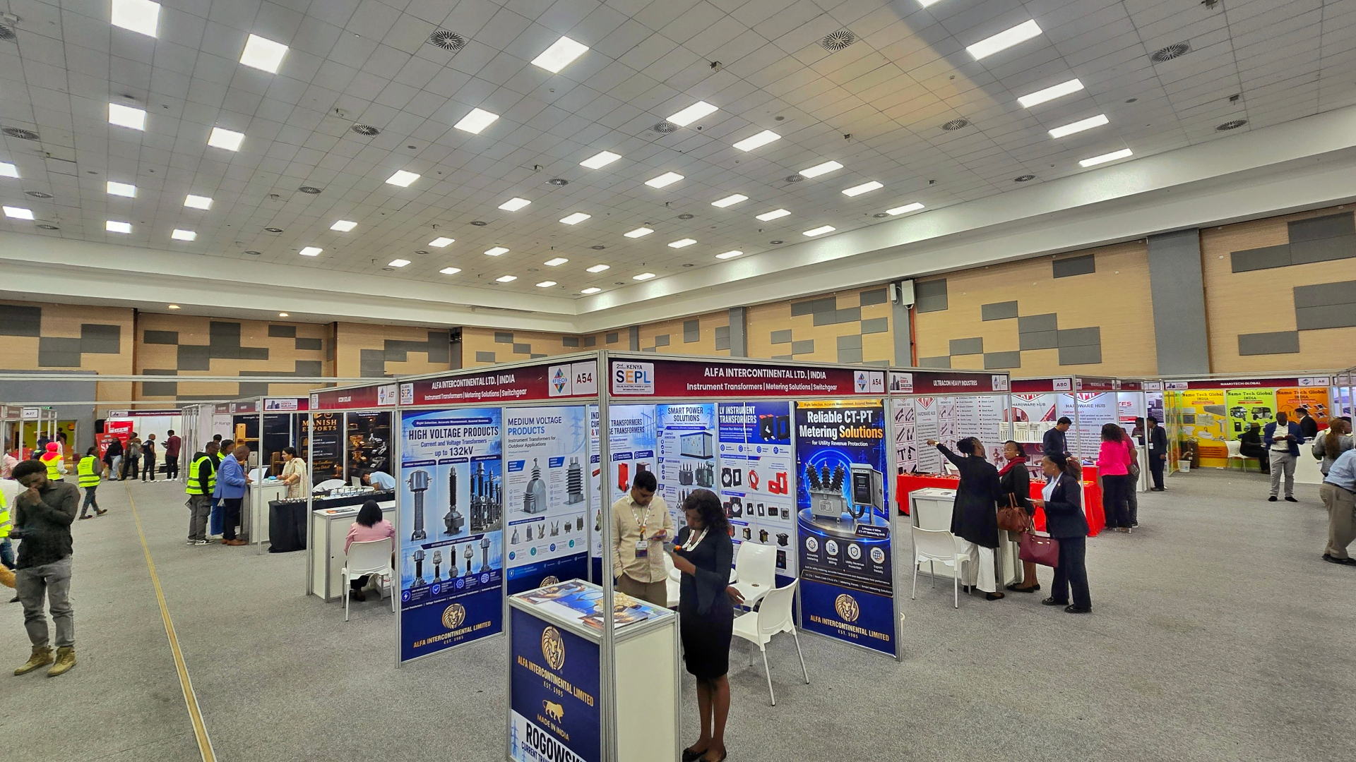 Wide view of an exhibition hall filled with branded booths and delegates at a KNCCI trade expo
